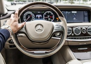 holding a steering wheel